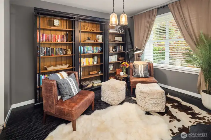 Black tile floors complete this library or formal dining room.