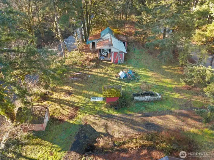 West end of home with creek and outbuildings