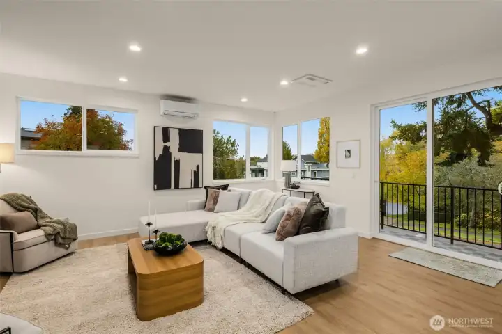 Large windows brighten the main living floor, making an enticing place to relax & entertain