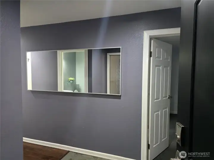Beauty of an entry, Mirror stays, door enters primary bedroom