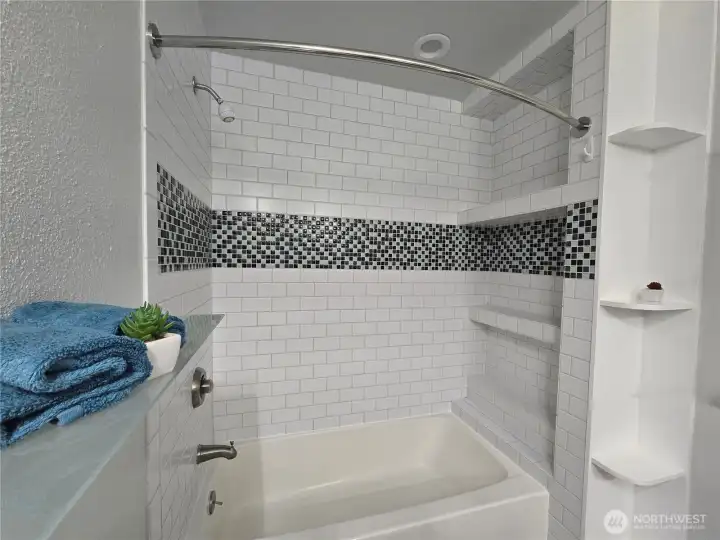 Custom tile with built in shelving in shower and out. Custom tile with built in shelving in shower and out.