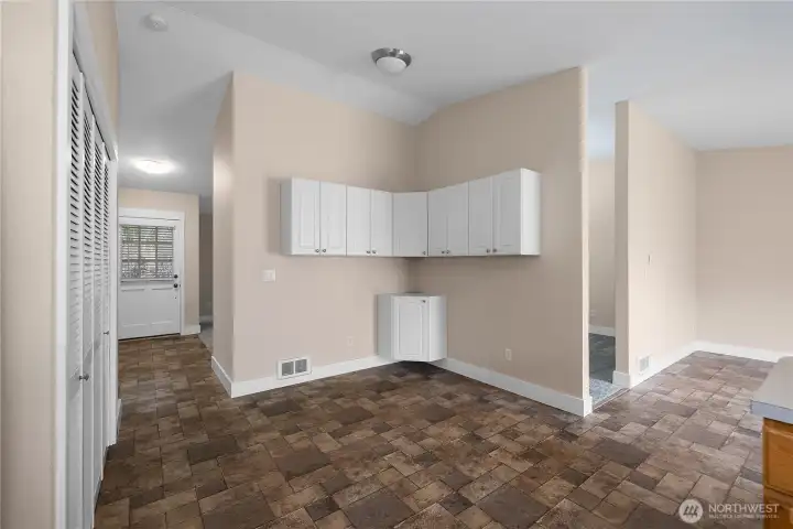Another view from kitchen toward entryway, kitchen nook, and additional living space directly off kitchen peninsula. This kitchen nook can easily seat 6 or can be utilized as a hobby space, pantry build out, etc.