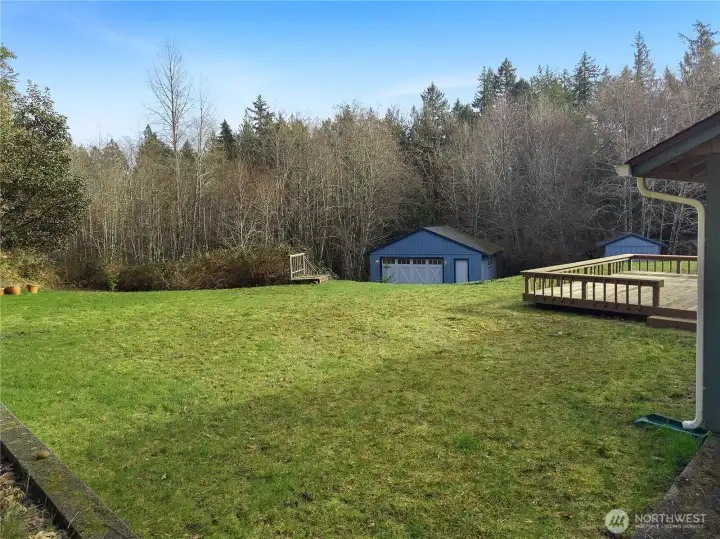 Alternate view from your cleared greenspace with views of your re-finished deck, shop in distance, and wooded surroundings. Plenty of space to garden, raise livestock, and enjoy the outdoors in pure privacy.