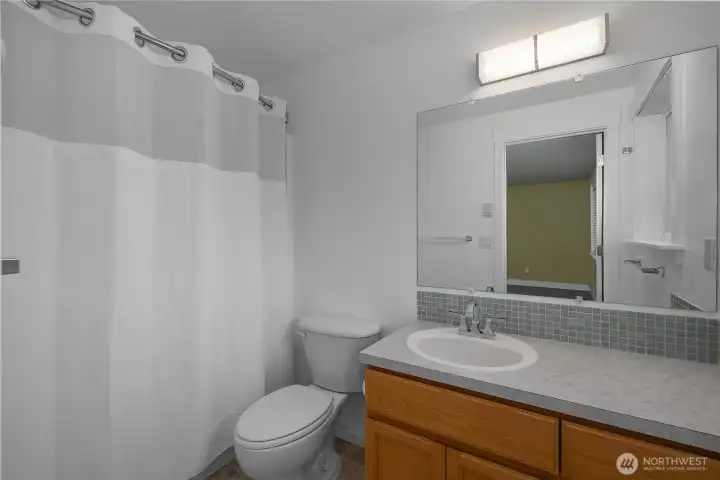 Your private primary bathroom lies directly off the bedroom. Natural light from window. Huge perk as this en suite is truly private and your own.