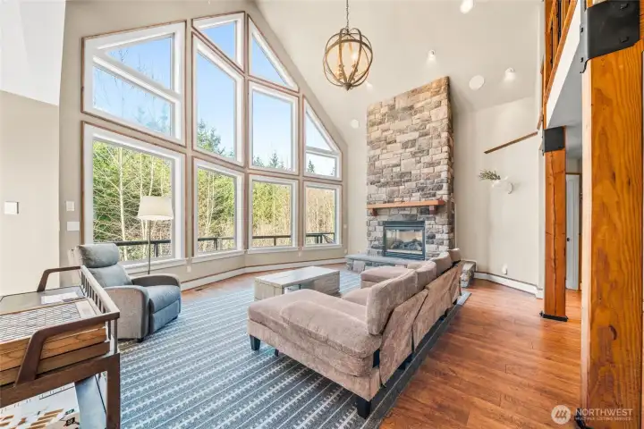 Floor to ceiling windows and stone fireplace. A beautiful space!