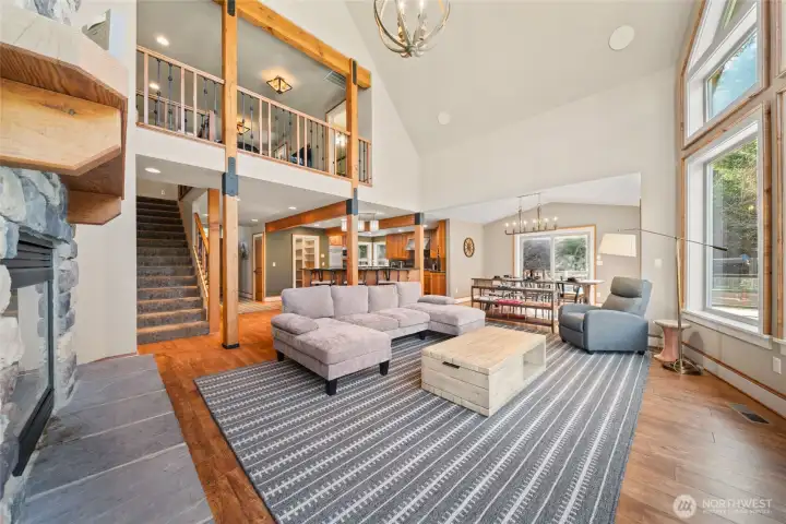 Large living room with tons of natural light. Loft above.