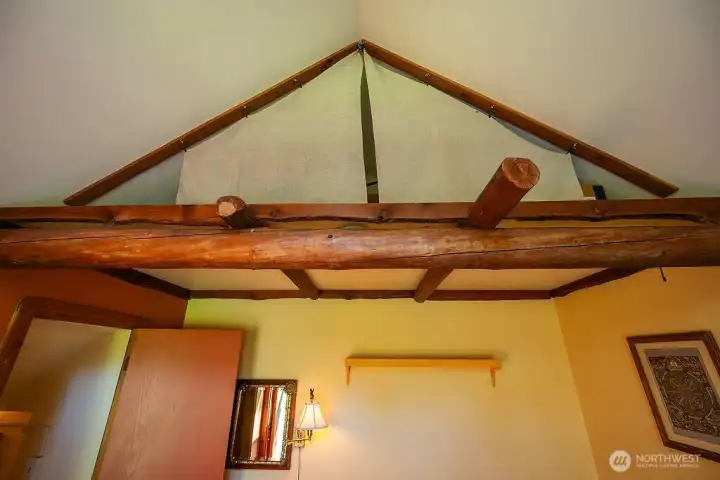 Loft space with salvaged timbers in main bedroom