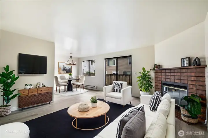 Virtually staged family room anchored by a wood burning fireplace.