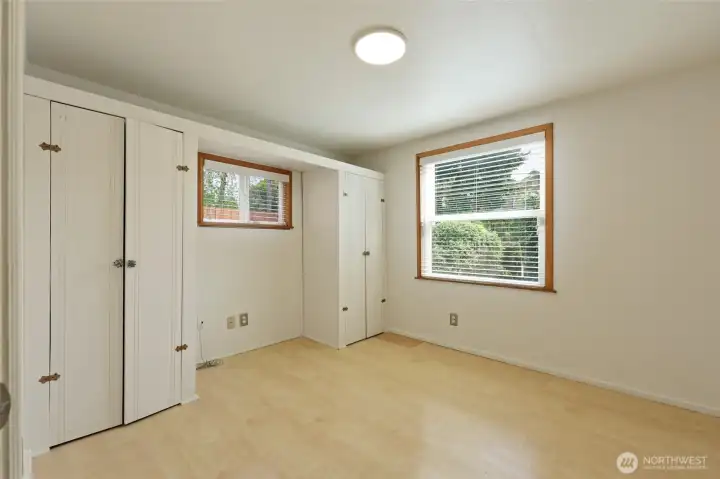 Primary bedroom with laminate flooring.