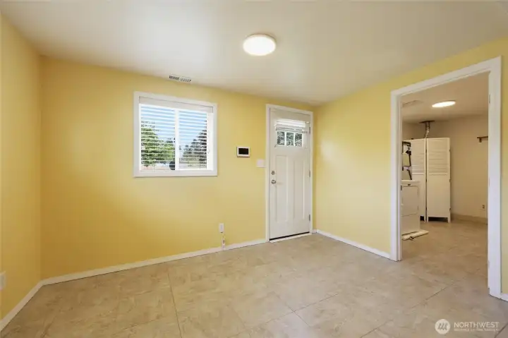 Dining room with door to back yard and utility room.