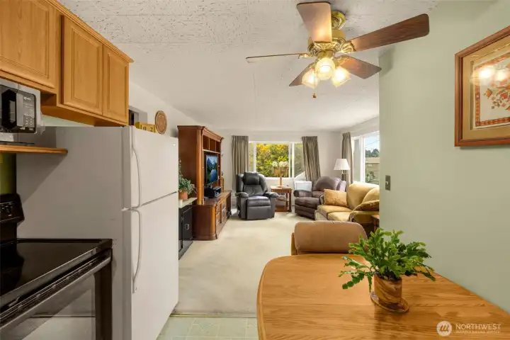 Open-concept living and dining area with a classic layout and vintage ceiling fan. Open-concept living and dining area with a classic layout and vintage ceiling fan.