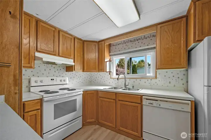 Kitchen with dishwasher, frig and electric stove. Kitchen with dishwasher, frig and electric stove.