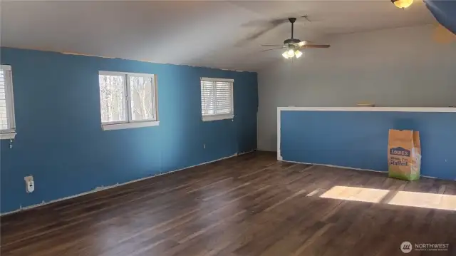 This is a partial view of the bonus room above the garage that has a newer pellet stove and is wired for wall heaters.