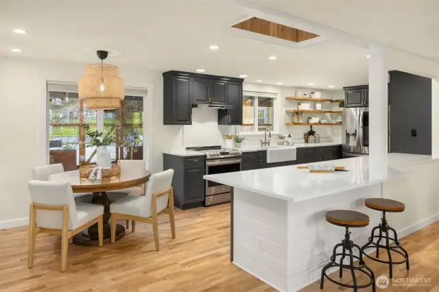 The kitchen includes space for counter dining and a table.