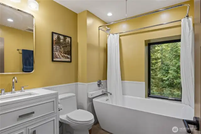 Full bathroom with soaking tub downstairs.