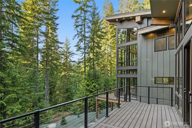 It is like walking through your own personal forest on the wrap around deck designed to take advantage of all the views that surround.