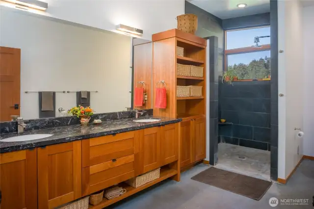 Primary bath has limestone with fossil counters, cherry cabinets and slate shower.