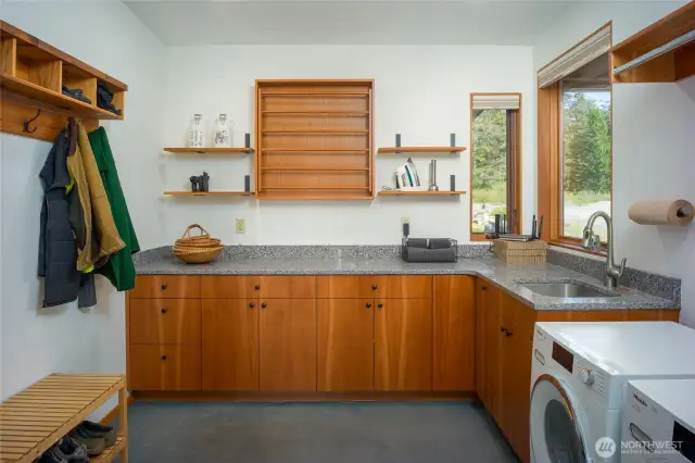 Laundry room has the coolest drying rack you have ever seen.