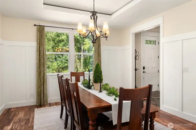 Elegant touches include wainscoting & a tray ceiling.