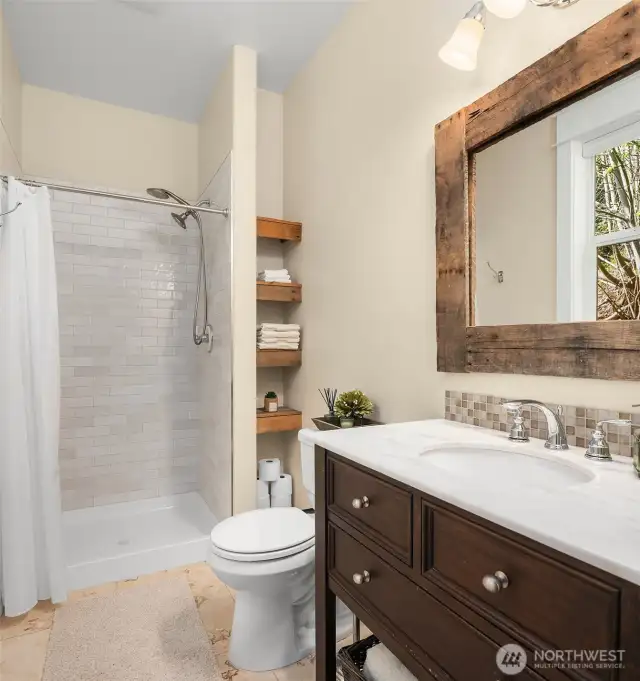 The hallway bath features a lovely vanity & barn-wood accents.