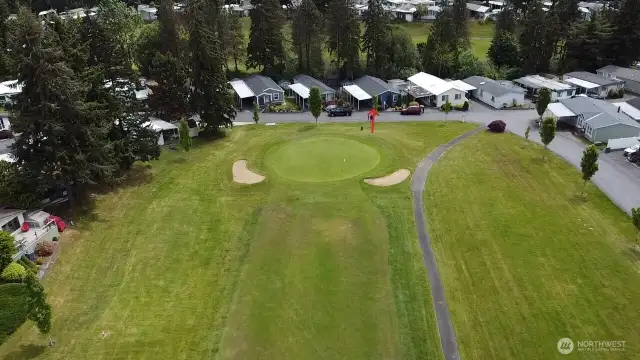Across the street from putting green.