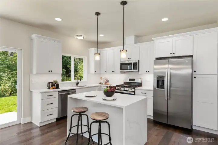 This island features striking waterfall edges, abundance of counter space and still room for casual dining. Sliding door to back yard. This island features striking waterfall edges, abundance of counter space and still room for casual dining. Sliding door to back yard.