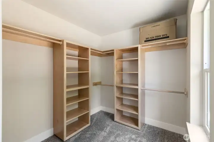Primary suite walk-in closet is complete with built in storage space.