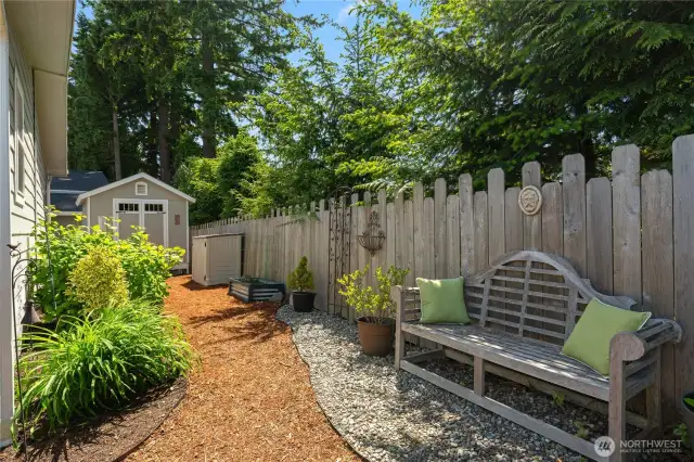 A serene place to read a book or just listen to the birds chirp. There are beautiful perennial plantings around the home. Great storage shed in background.