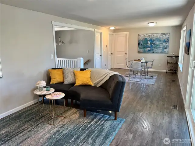 Great room with fireplace, deck access opens to dining space and eat-in kitchen.