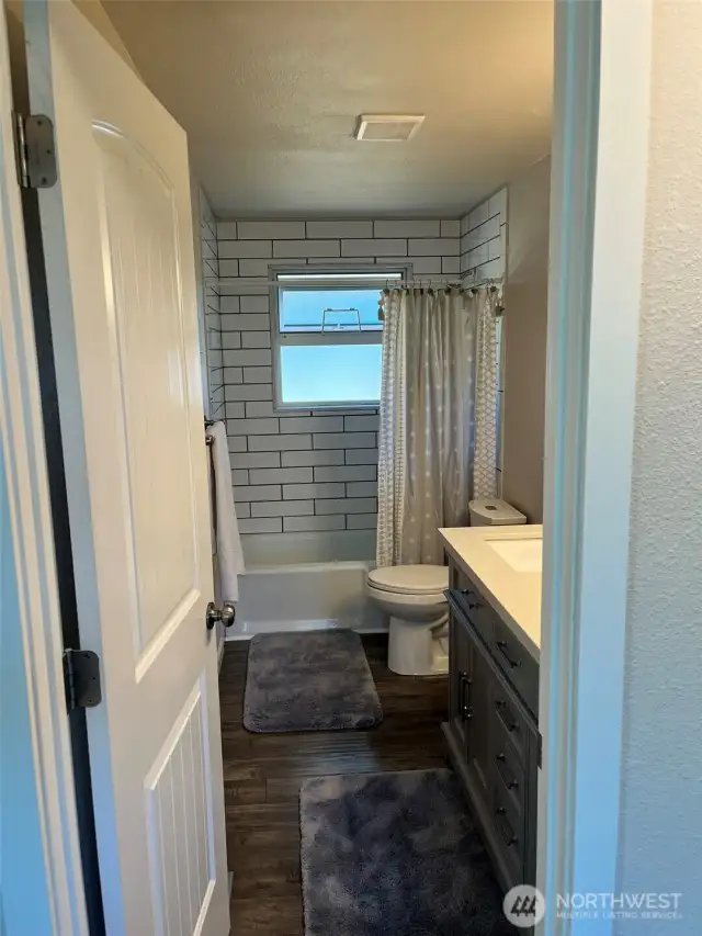 Main full bathroom with double sink vanity.