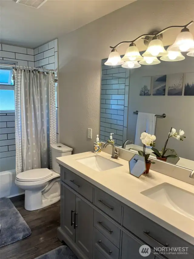 Main full bathroom with double sink vanity.