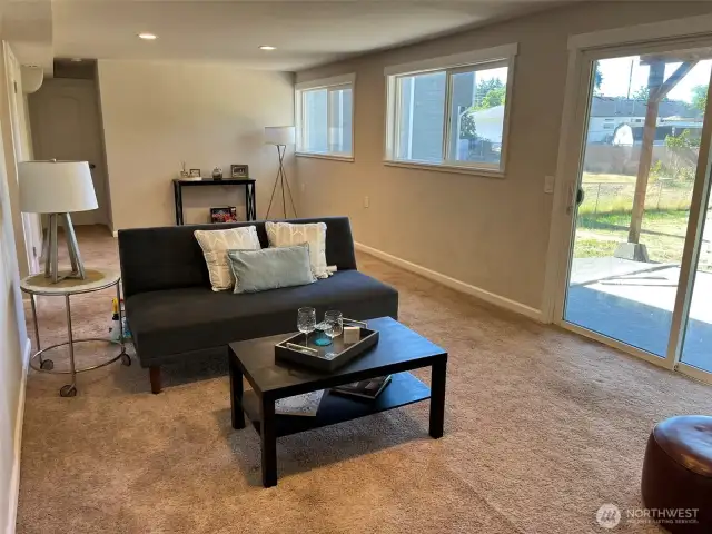 Recreation room with fireplace and access to covered patio.