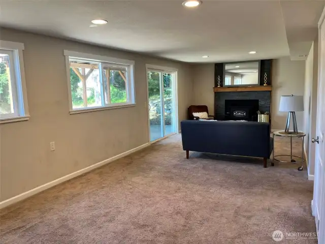 Recreation room with fireplace and access to covered patio.