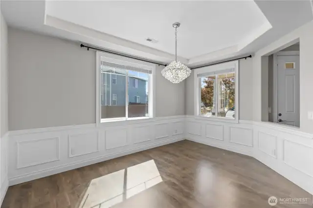 Dining Room with Fine Touches Such as Wainscoting and a Beautiful Chandelier Will Be Sure to Dazzle Your Guests.