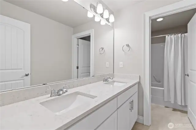 Upper-Level Guest Bathroom with Dual Vanity, Separate Shower and Water Closet. Upgraded Quartz Countertops and Tile Flooring.