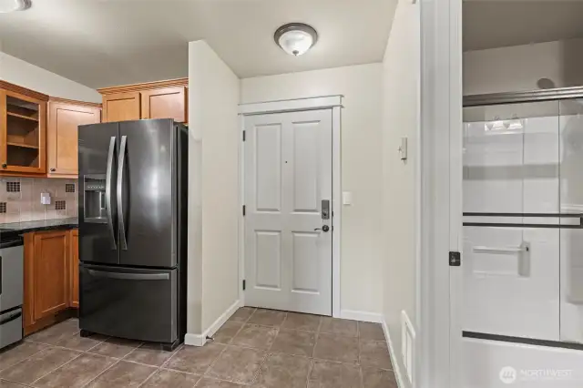 Looking toward entry door with kitchen to the left and Hall bathroom/laundry to the right