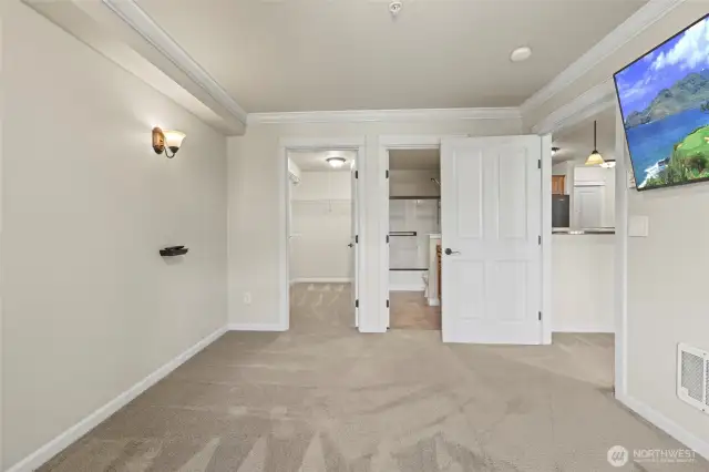 Primary bedroom facing full bathroom and walk-in closet
