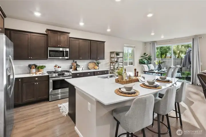 Open concept kitchen and living with oversized quartz island