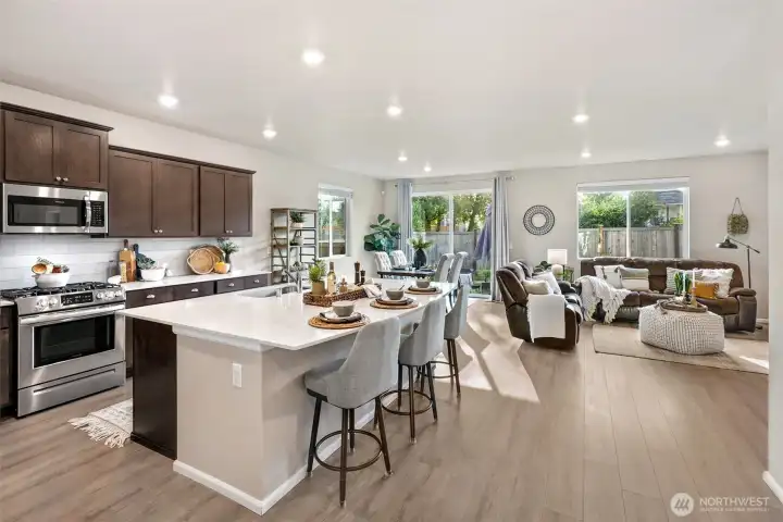Open concept kitchen and living with oversized quartz island