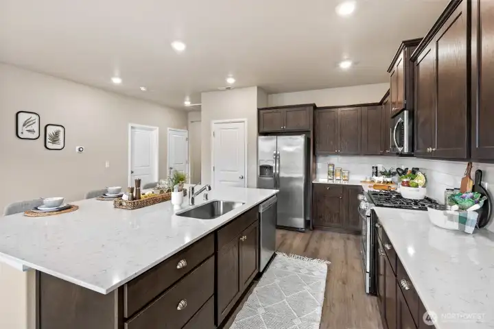 Open concept kitchen and living with oversized quartz island