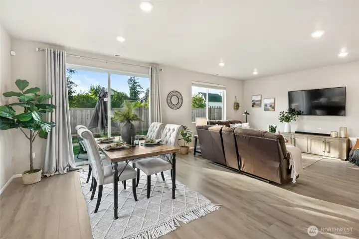 Open concept living and dining area with lots of natural light and access to the backyard