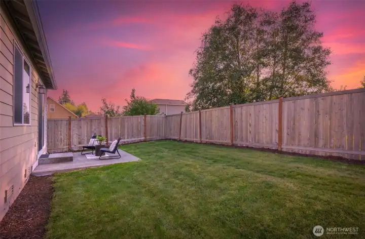 Spacious fenced backyard with patio