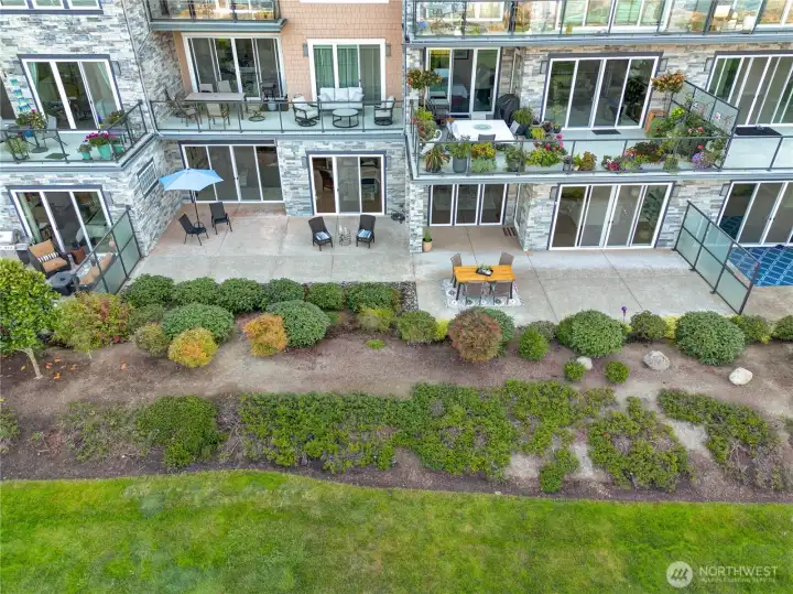 This ground-floor residence features an expansive patio—perfect for morning coffee, sunset dining, and effortless entertaining—all set against the breathtaking backdrop of Puget Sound.
