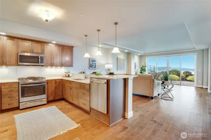 An open-concept layout is elevated by rich engineered hardwood floors and floor-to-ceiling windows that bathe the space in radiant natural light—creating a warm, refined ambiance throughout.