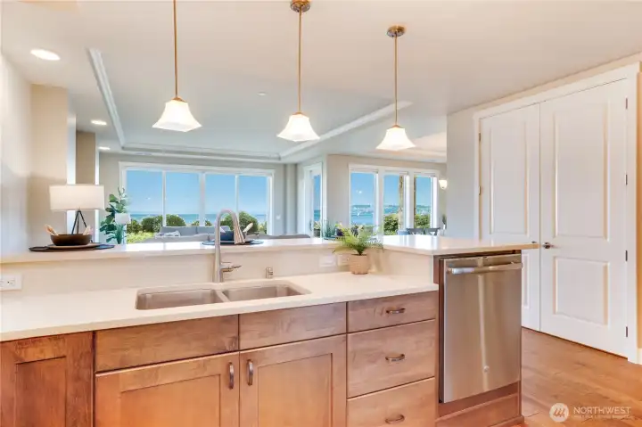 Even everyday tasks feel indulgent with views like this—enjoy washing up at the kitchen sink while gazing through expansive windows that fill the space with radiant natural light. Plus, a brand-new garbage disposal and a counter-height dishwasher adds modern convenience to this gourmet setup.