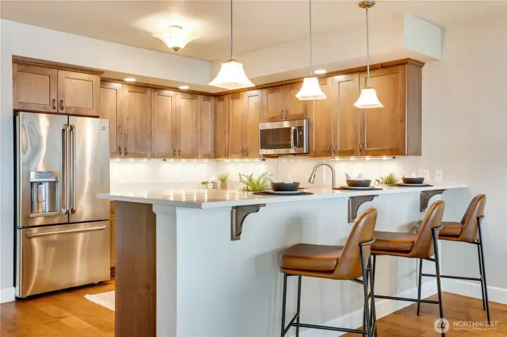The oversized breakfast bar provides casual dining, generous prep space, and a seamless connection to the heart of the home.