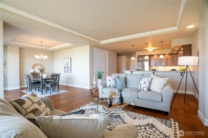 A rare distinction in this building, the formal dining room brings elevated elegance to an open-concept design—where tray ceilings, crown molding, and sweeping views enrich every moment. The generous pantry adds both function and finesse, thoughtfully designed to meet every culinary need.