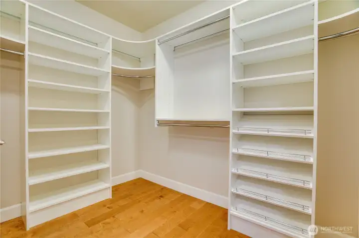 A generous walk-in closet with custom shelving and ample space—designed to keep your wardrobe beautifully organized and easily accessible.