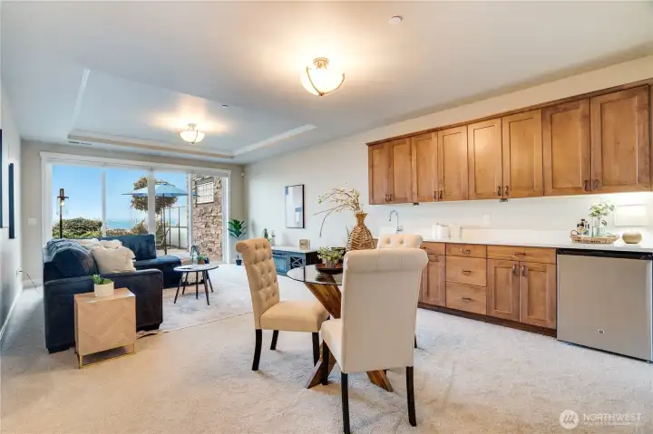 Uniquely appointed with its own living space, this family room features expansive windows, new carpet, a sleek wet bar, and built-in storage—designed for entertaining, relaxing, and everything in between.