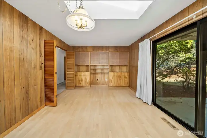 Family room and dinette area feature maple hardwood and built in storage